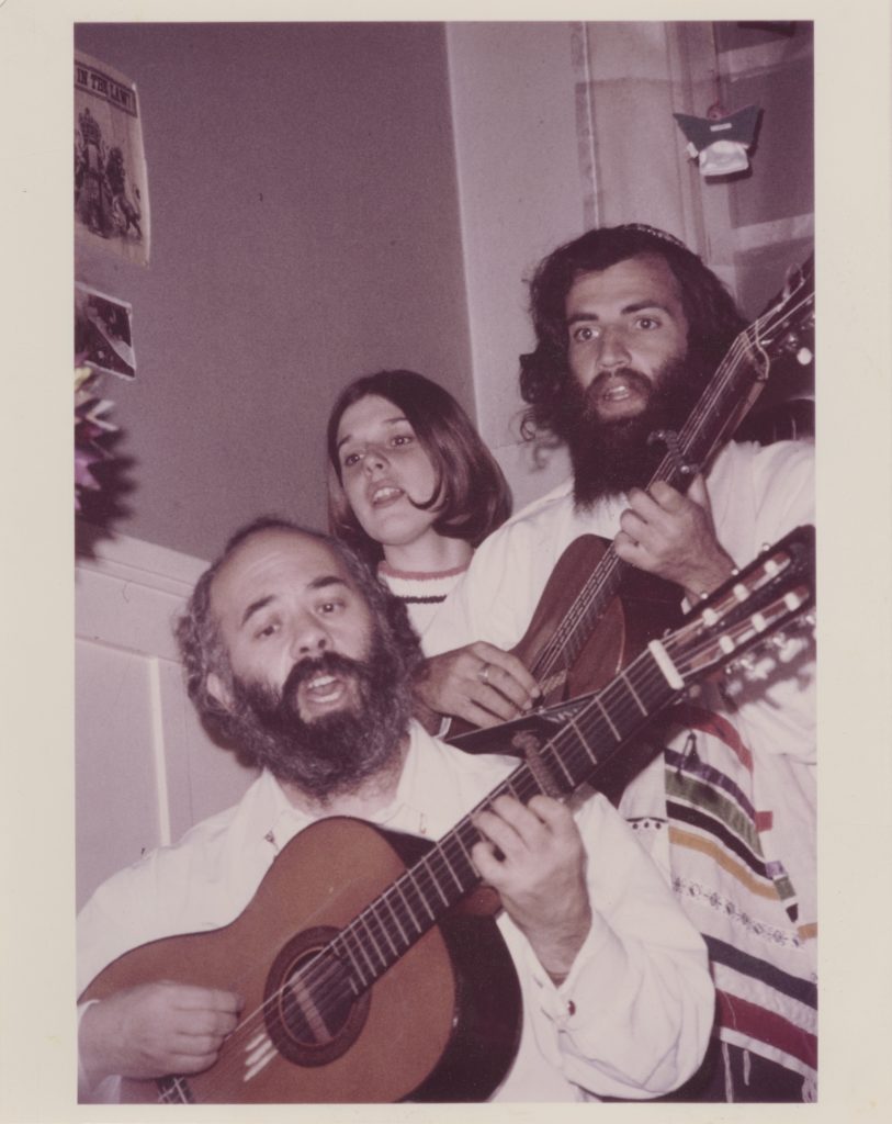 Aryae Coopersmith and Shlomo Carlebach singing and playing guitar on the steps inside the House of Love and Prayer on Arguello Blvd. Photo by Marvin Kussoy, courtesy of Yehudit and Reuven Goldfarb.
